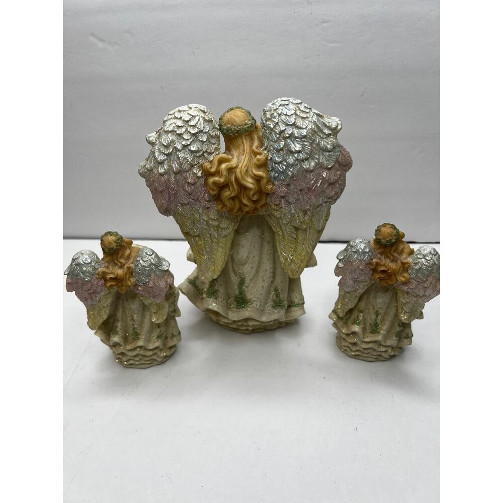 Three Angels Singing one Large Angel and Two Small Angels Holding Choir Book